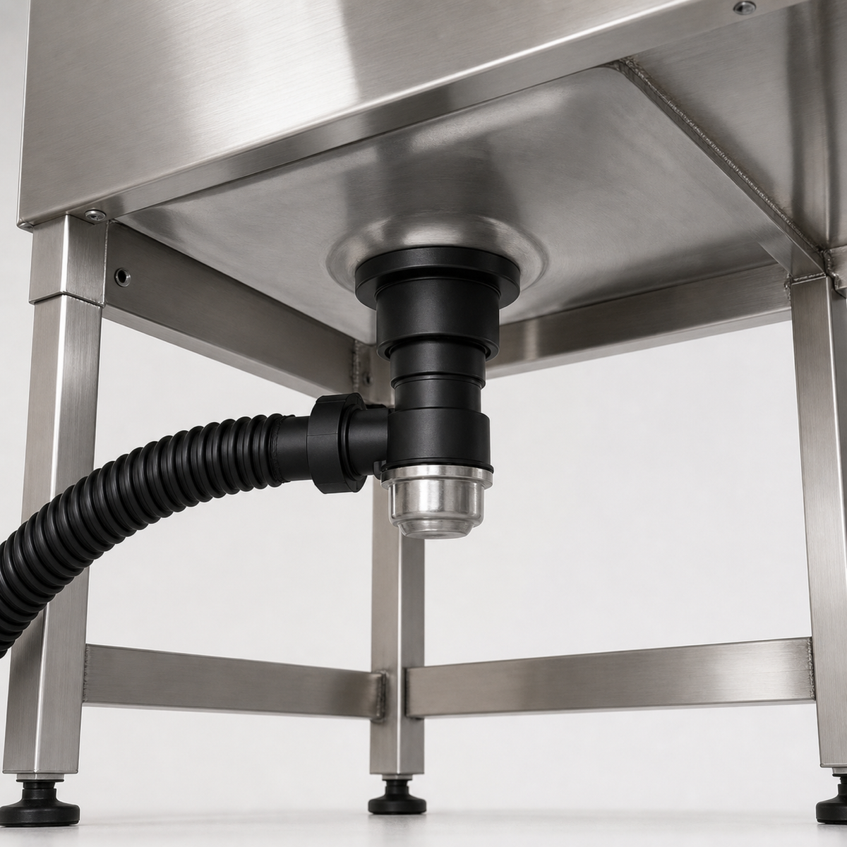 Drain assembly and black corrugated drain hose below the basin